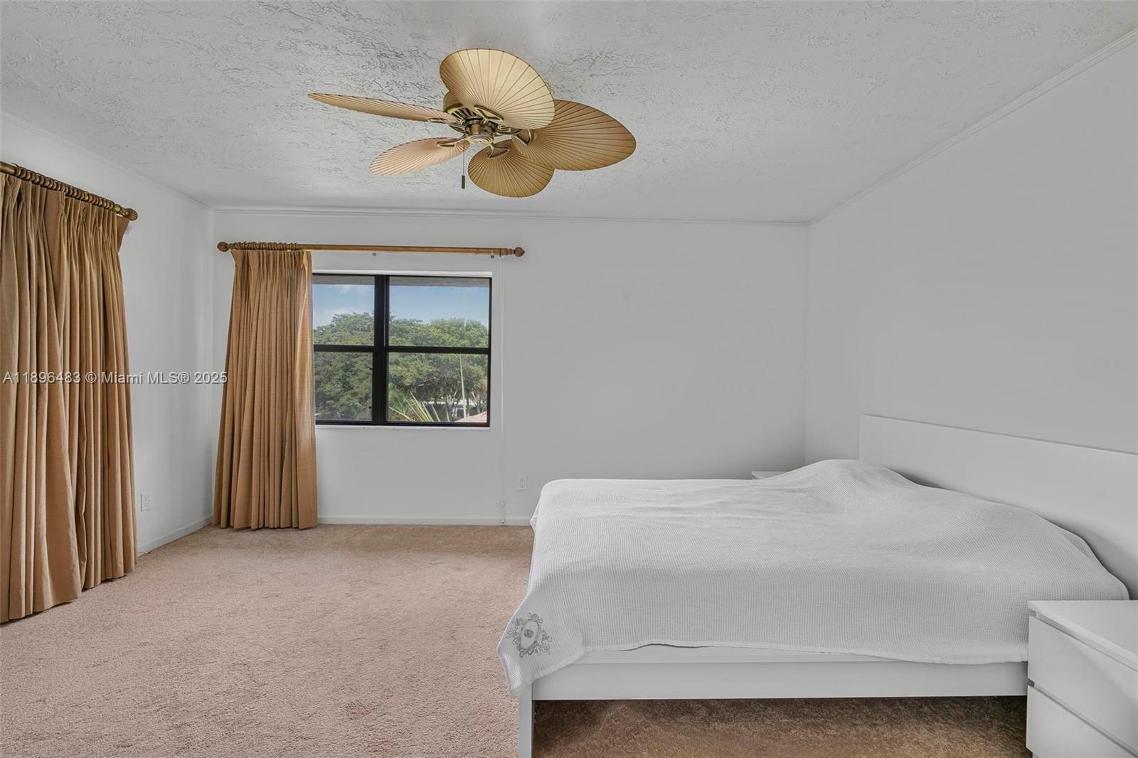 7507 La Paz Boulevard, Unit 407 Boca Raton, FL 33433 - Photo 18 of 34 a bedroom with a bed and a chandelier