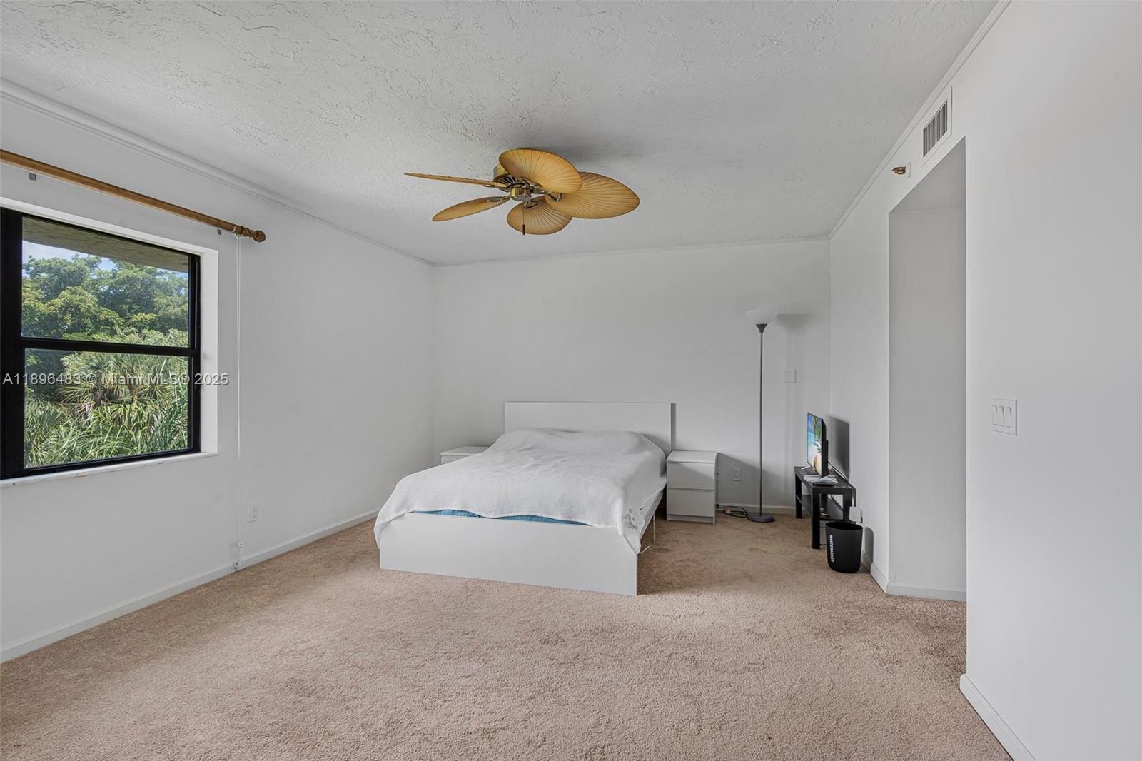 7507 La Paz Boulevard, Unit 407 Boca Raton, FL 33433 - Photo 19 of 34 a bedroom with a bed and a window