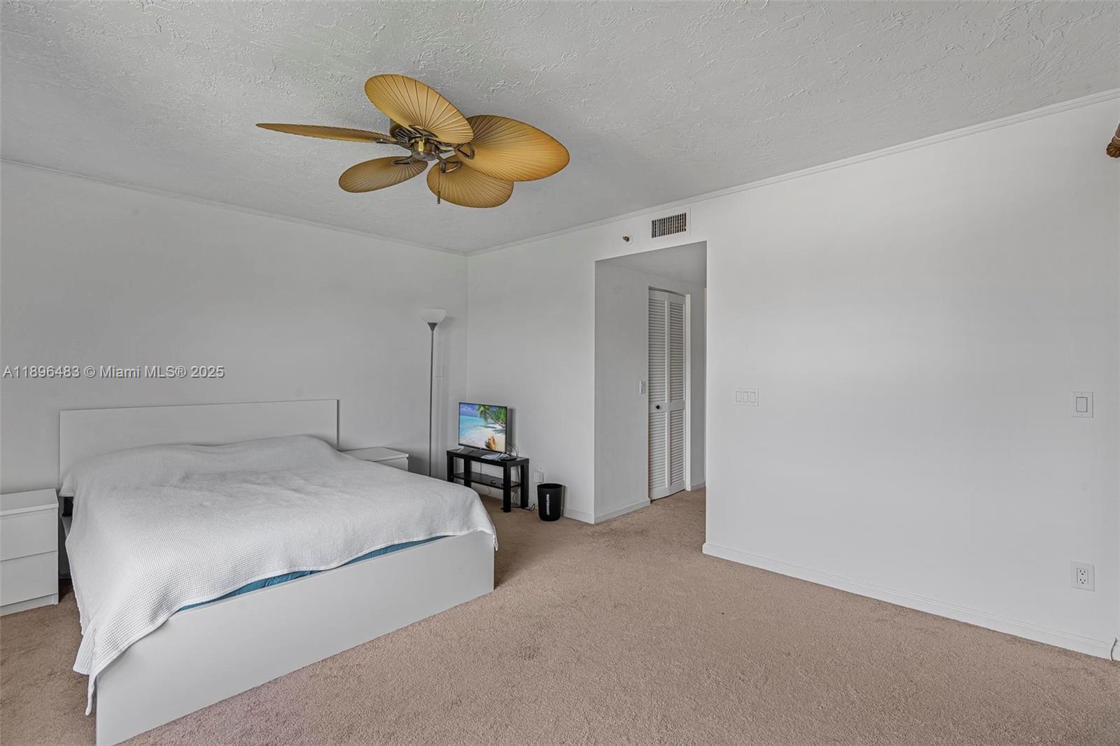 7507 La Paz Boulevard, Unit 407 Boca Raton, FL 33433 - Photo 20 of 34 a bedroom with a bed and a chandelier