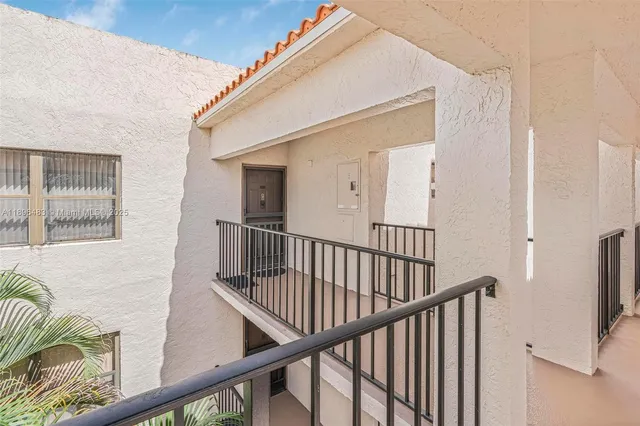 a view of staircase with railing and a rug