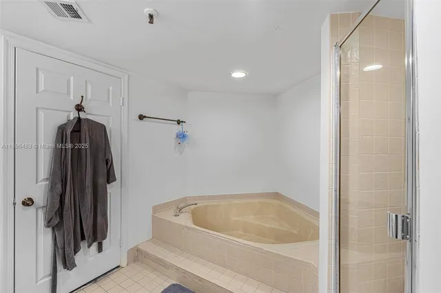 a bathroom with a tub and a shower