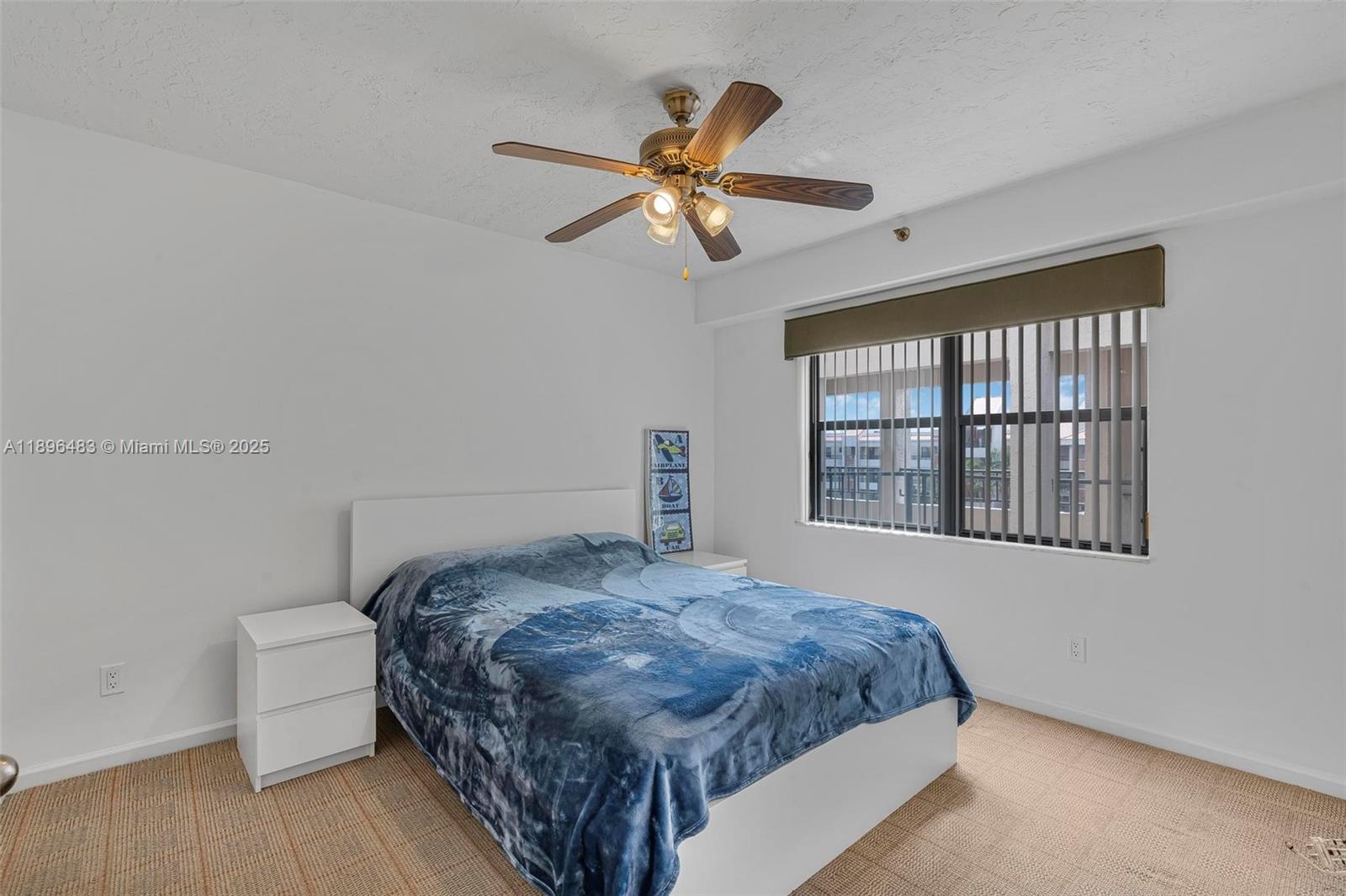 7507 La Paz Boulevard, Unit 407 Boca Raton, FL 33433 - Photo 25 of 34 a bedroom with a bed and a window