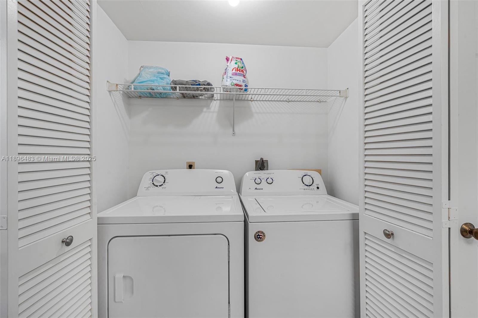 7507 La Paz Boulevard, Unit 407 Boca Raton, FL 33433 - Photo 28 of 34 a utility room with dryer and washer