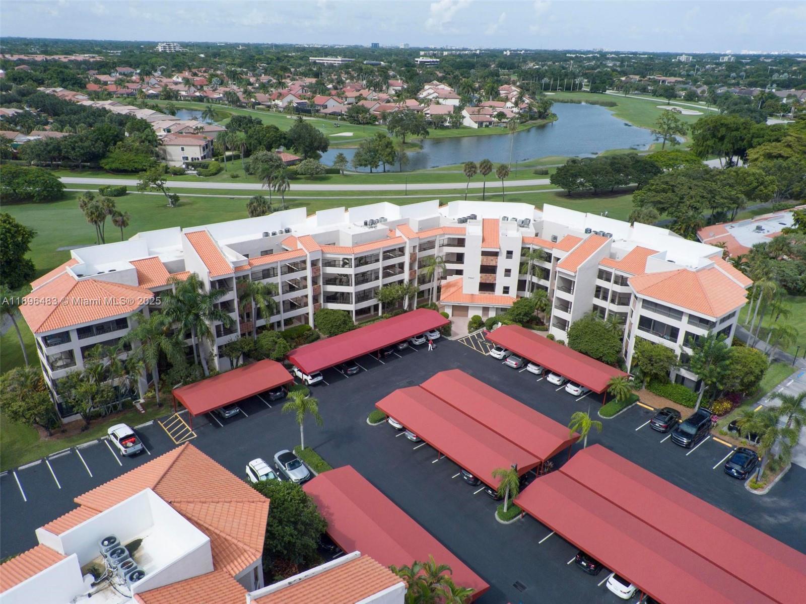 7507 La Paz Boulevard, Unit 407 Boca Raton, FL 33433 - Photo 30 of 34 an aerial view of residential houses with outdoor space and lake view