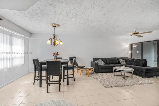 a living room with furniture a window and a dining table