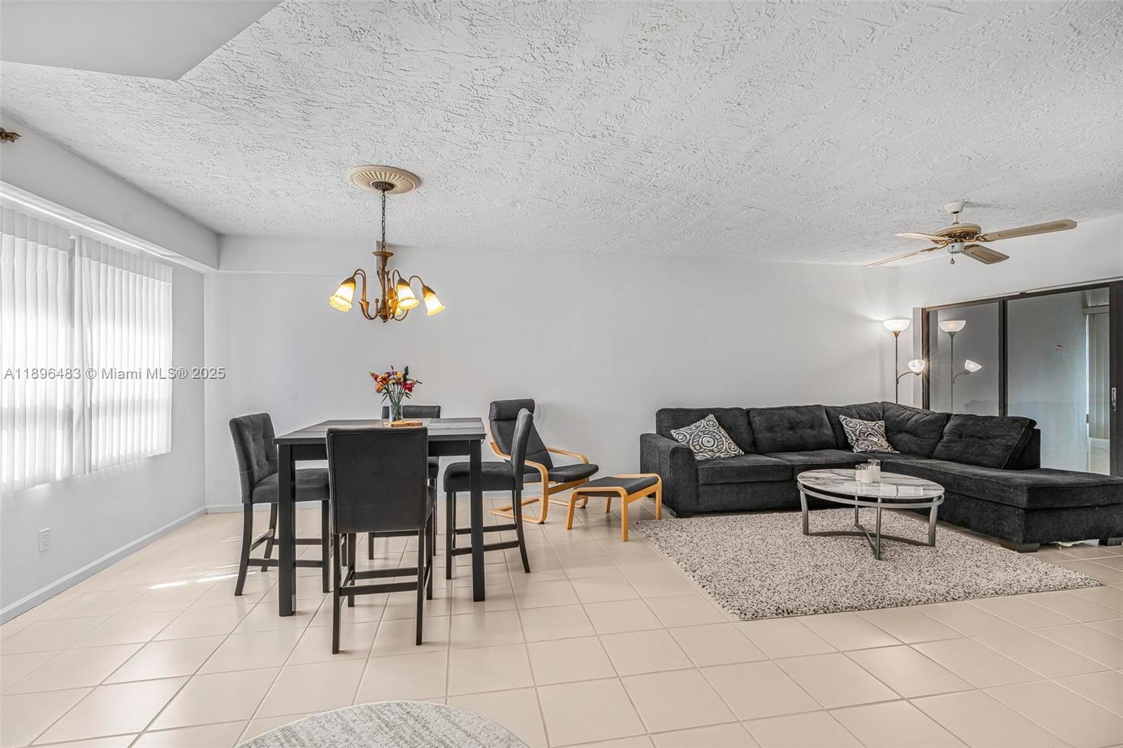 7507 La Paz Boulevard, Unit 407 Boca Raton, FL 33433 - Photo 5 of 34 a living room with furniture a window and a dining table