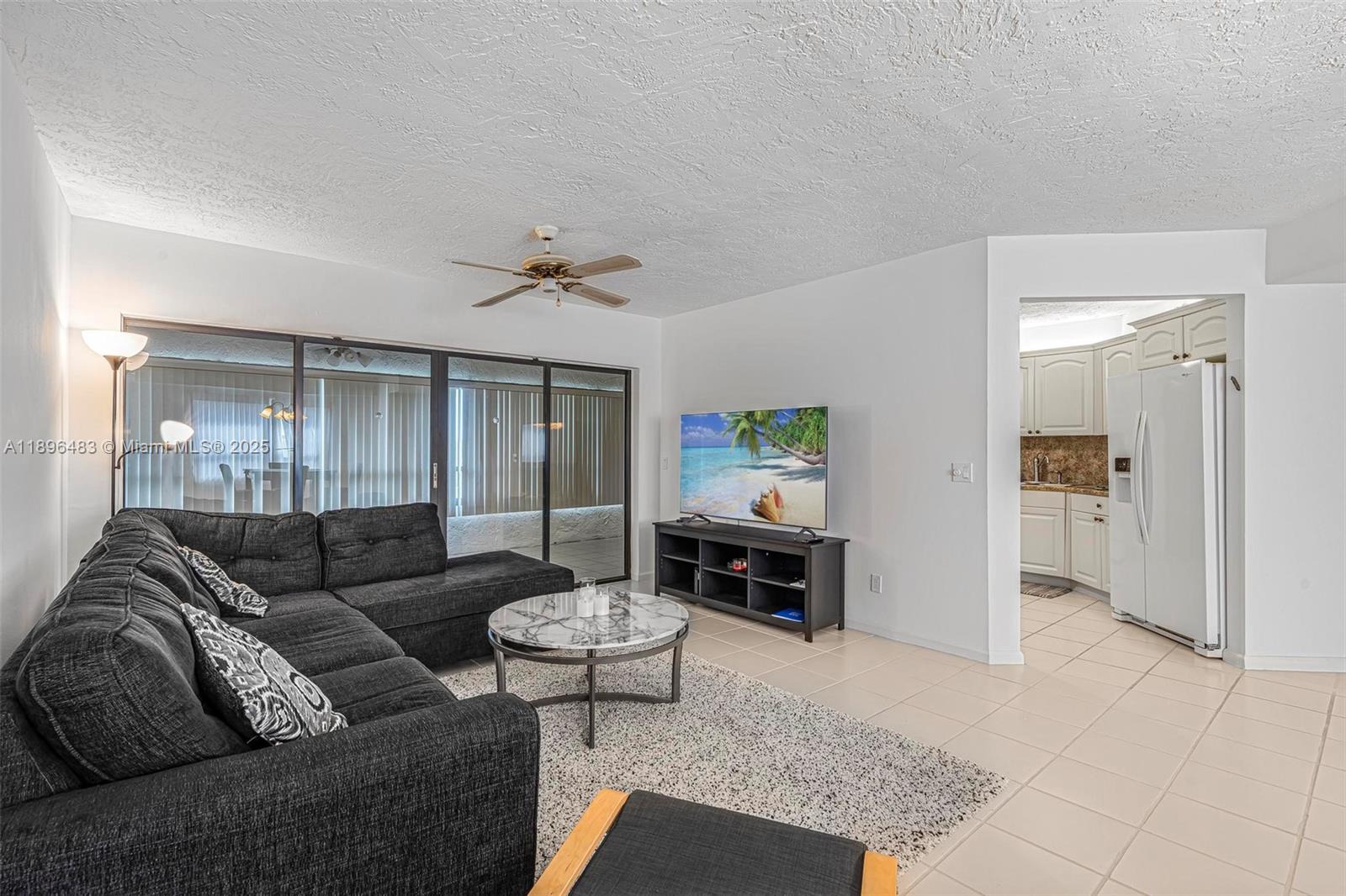 7507 La Paz Boulevard, Unit 407 Boca Raton, FL 33433 - Photo 6 of 34 a living room with furniture and a table
