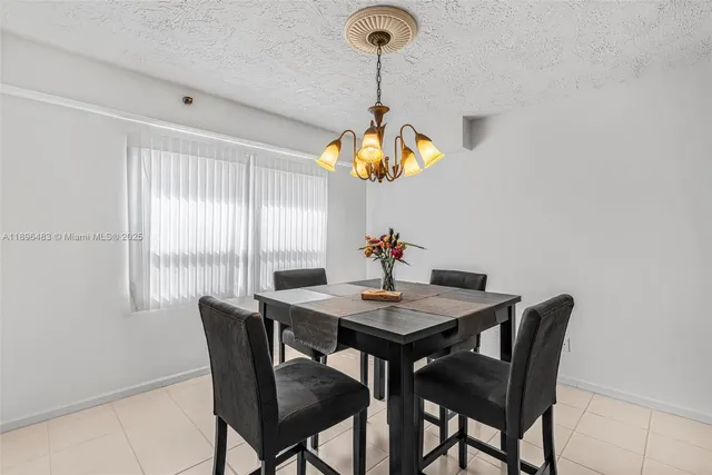 a view of a dining room with a table and chairs