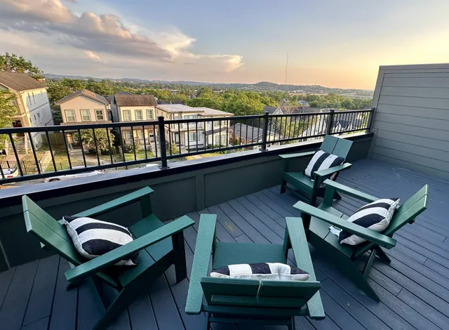 a roof deck with a table and chairs