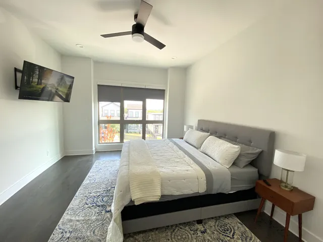 a bedroom with a large bed and a tv