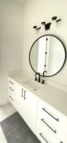 a bathroom with a sink and mirror