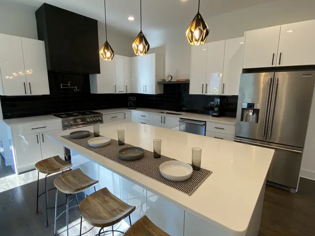 a kitchen with a sink a stove and a refrigerator
