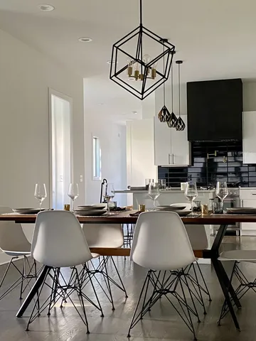 a view of a dining room with furniture wooden floor and a chandelier