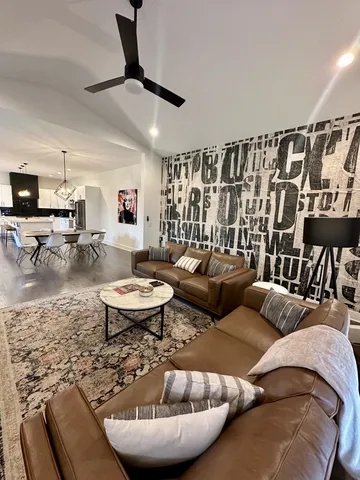 a living room with furniture and kitchen view