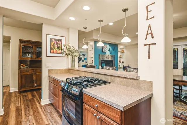 a kitchen with stainless steel appliances granite countertop a stove and a sink