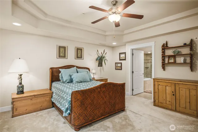 a bedroom with a large bed and a chandelier