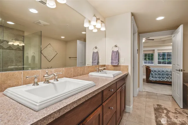 a bathroom with a sink double vanity and a mirror
