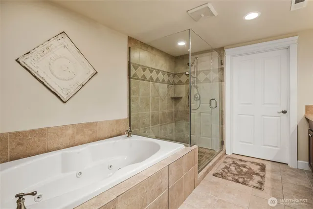 a spacious bathroom with a bathtub and shower