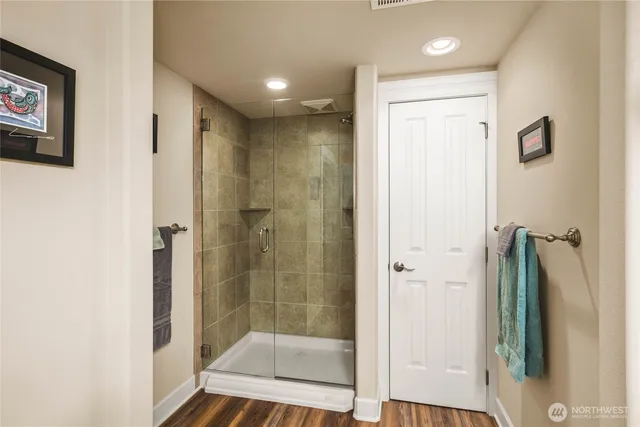 a bathroom with a shower and a sink