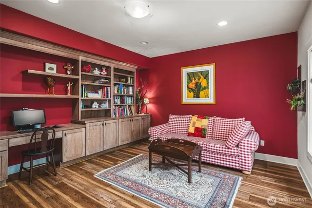 a living room with furniture and a bookshelf