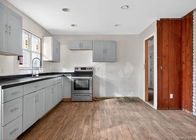 a kitchen with granite countertop a sink and cabinets