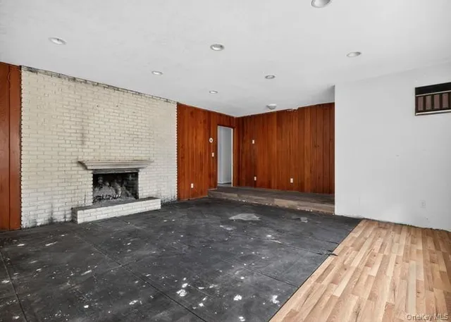 a view of an empty room with a fireplace