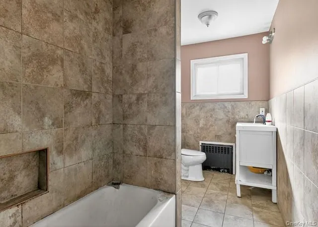 a bathroom with a toilet and a sink