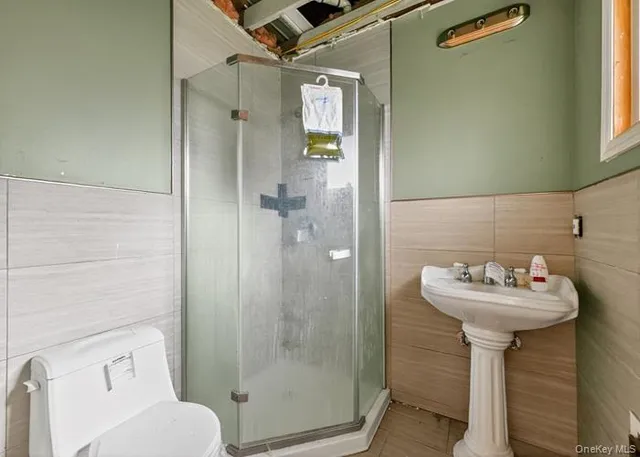 a bathroom with a sink mirror toilet and shower
