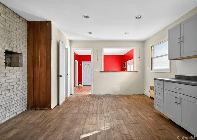 a view of kitchen with wooden floor and electronic appliances