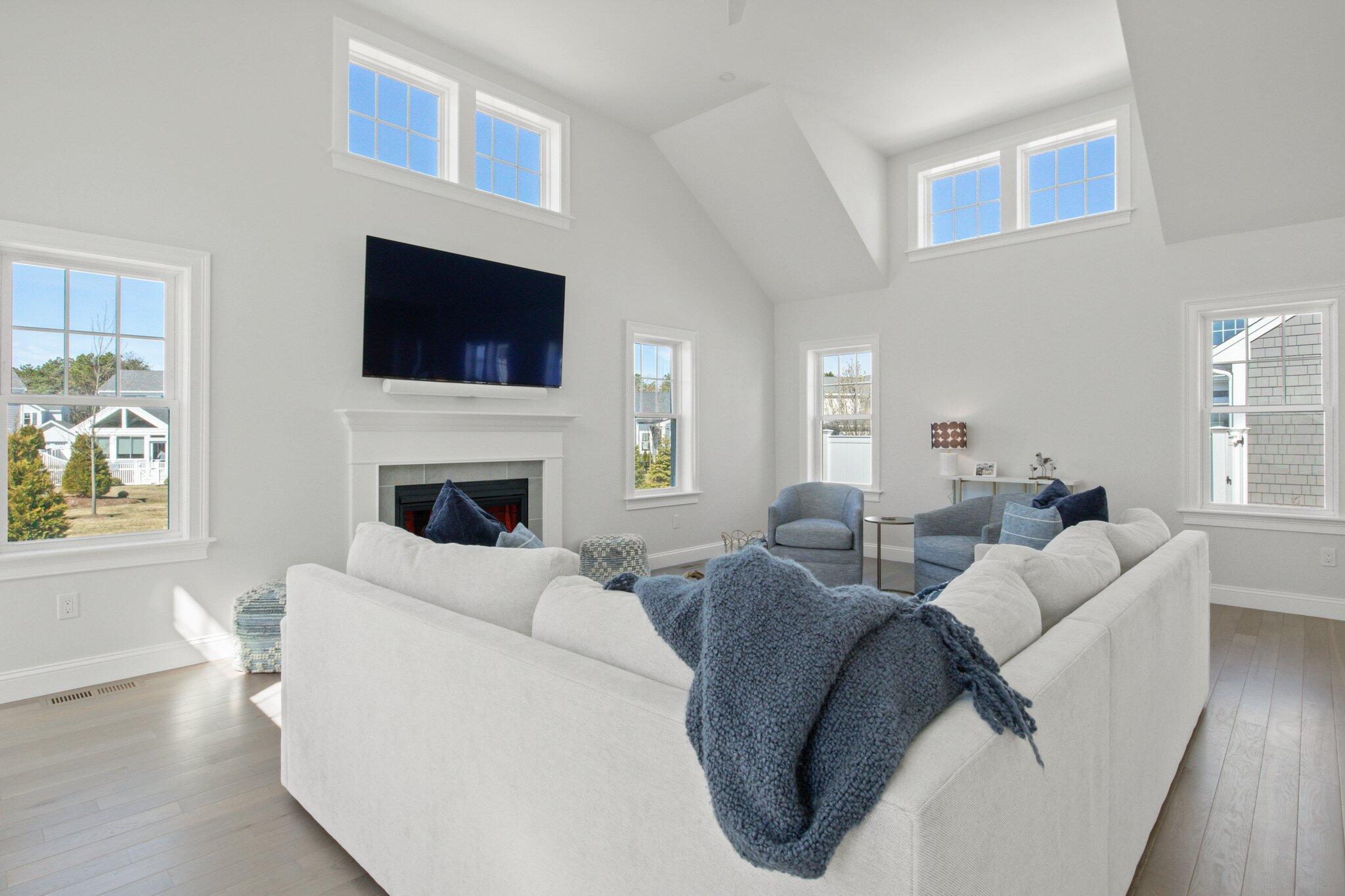 85 Cobblestone Circle Mashpee, MA 02649 - Photo 12 of 42 a living room with furniture a fireplace and a flat screen tv