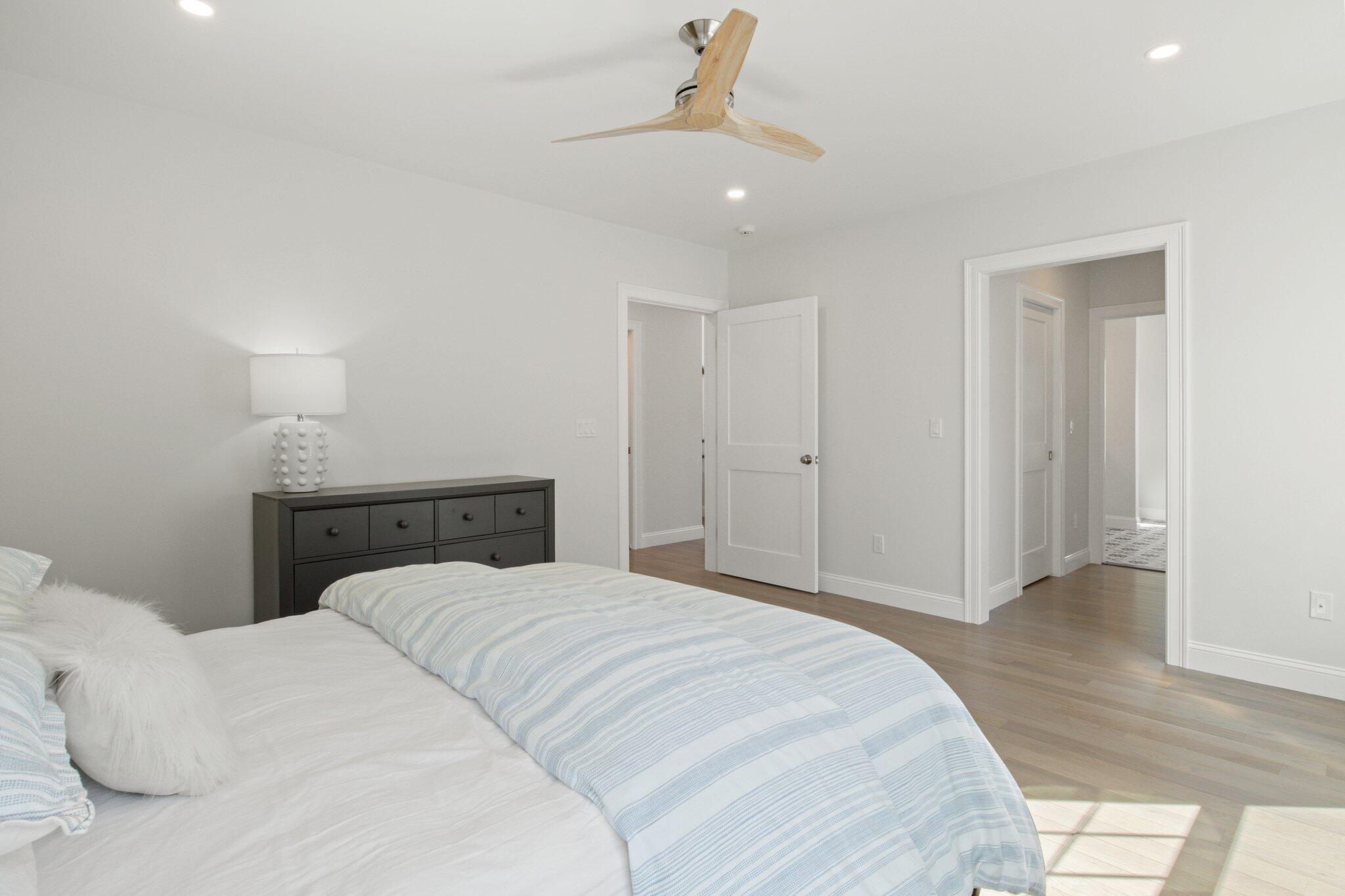 85 Cobblestone Circle Mashpee, MA 02649 - Photo 18 of 42 a bedroom with a bed and a ceiling fan