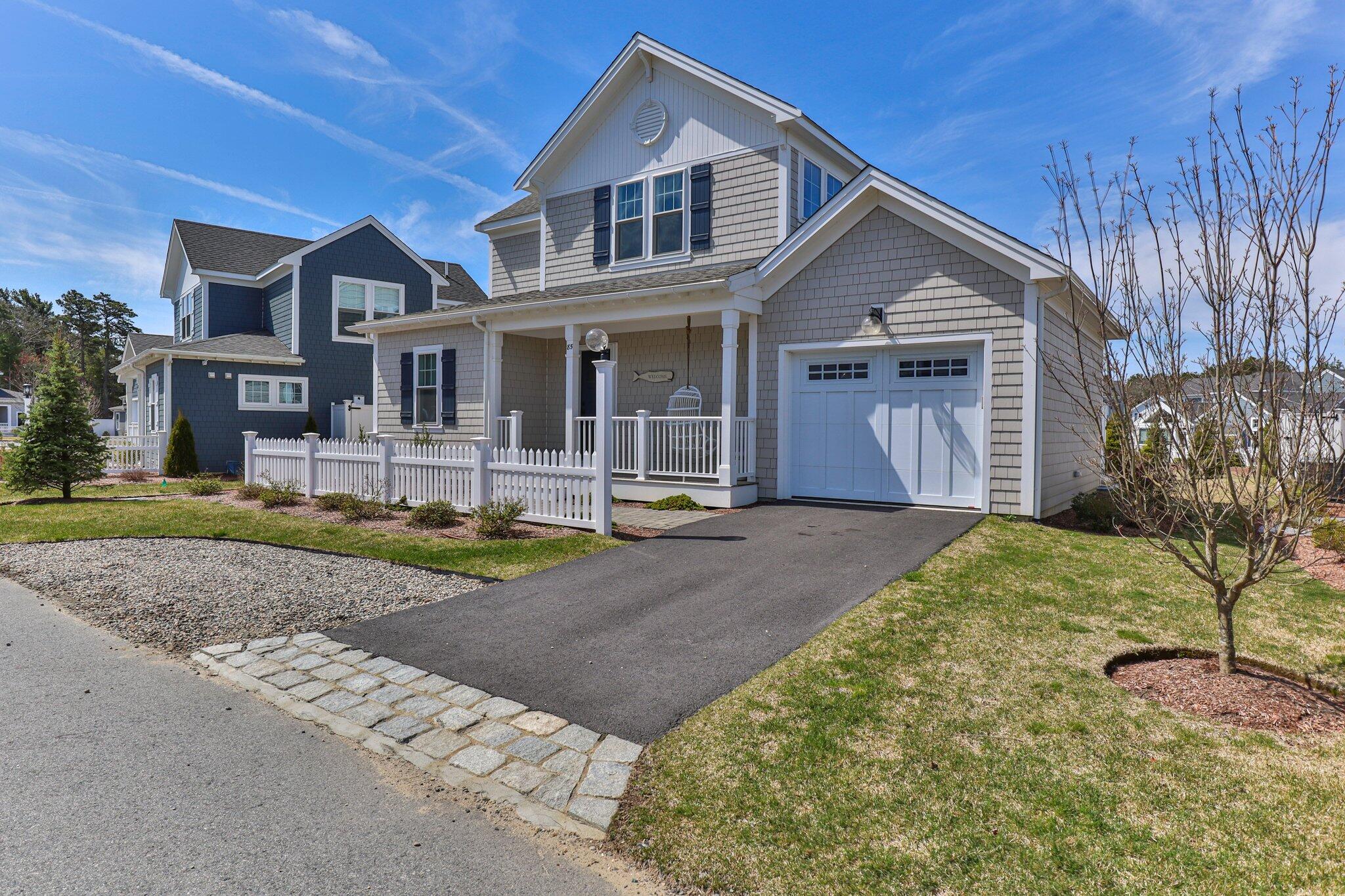 85 Cobblestone Circle Mashpee, MA 02649 - Photo 2 of 42 a front view of a house with a yard