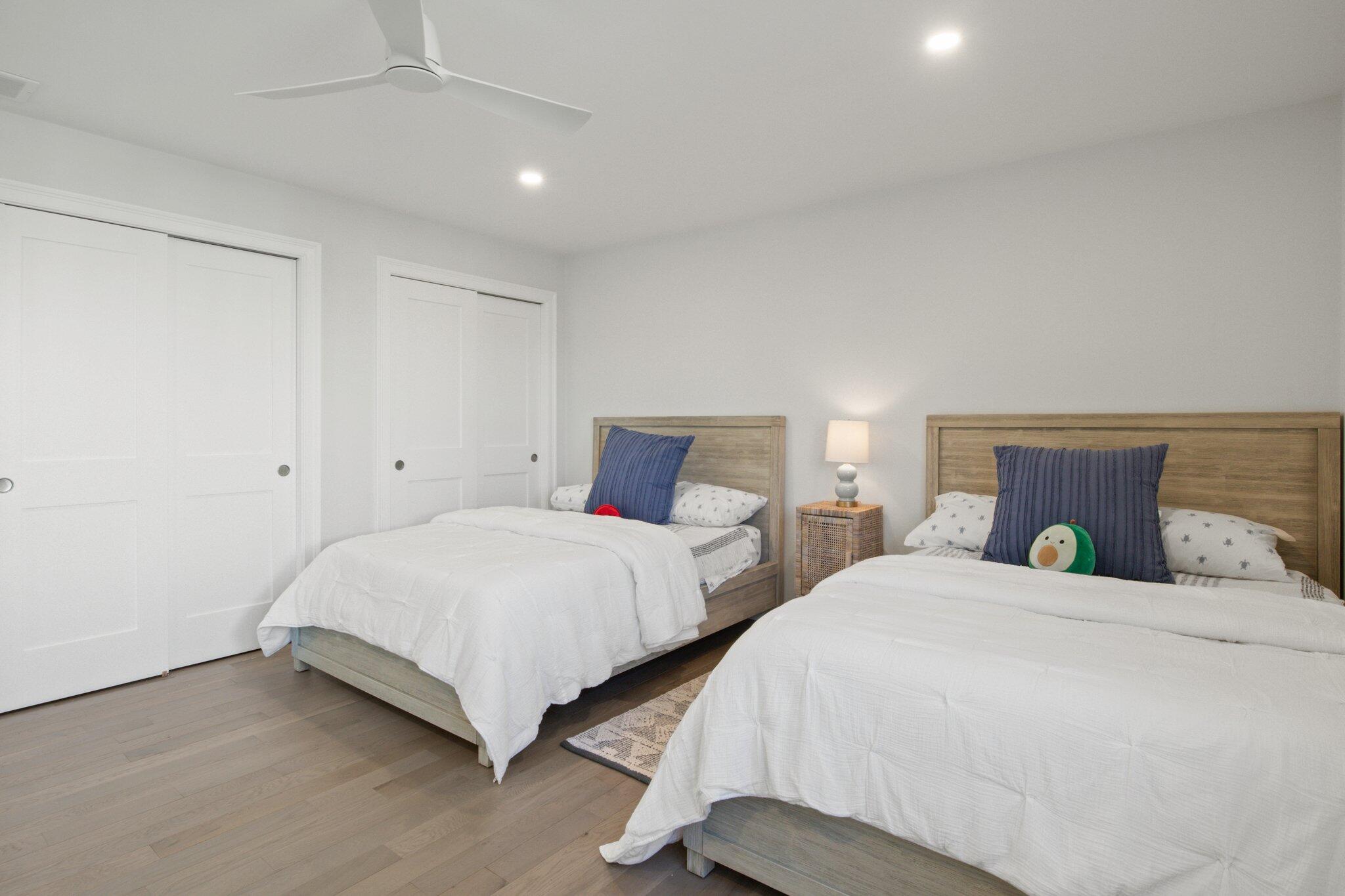 85 Cobblestone Circle Mashpee, MA 02649 - Photo 26 of 42 a bedroom with two beds and a chandelier