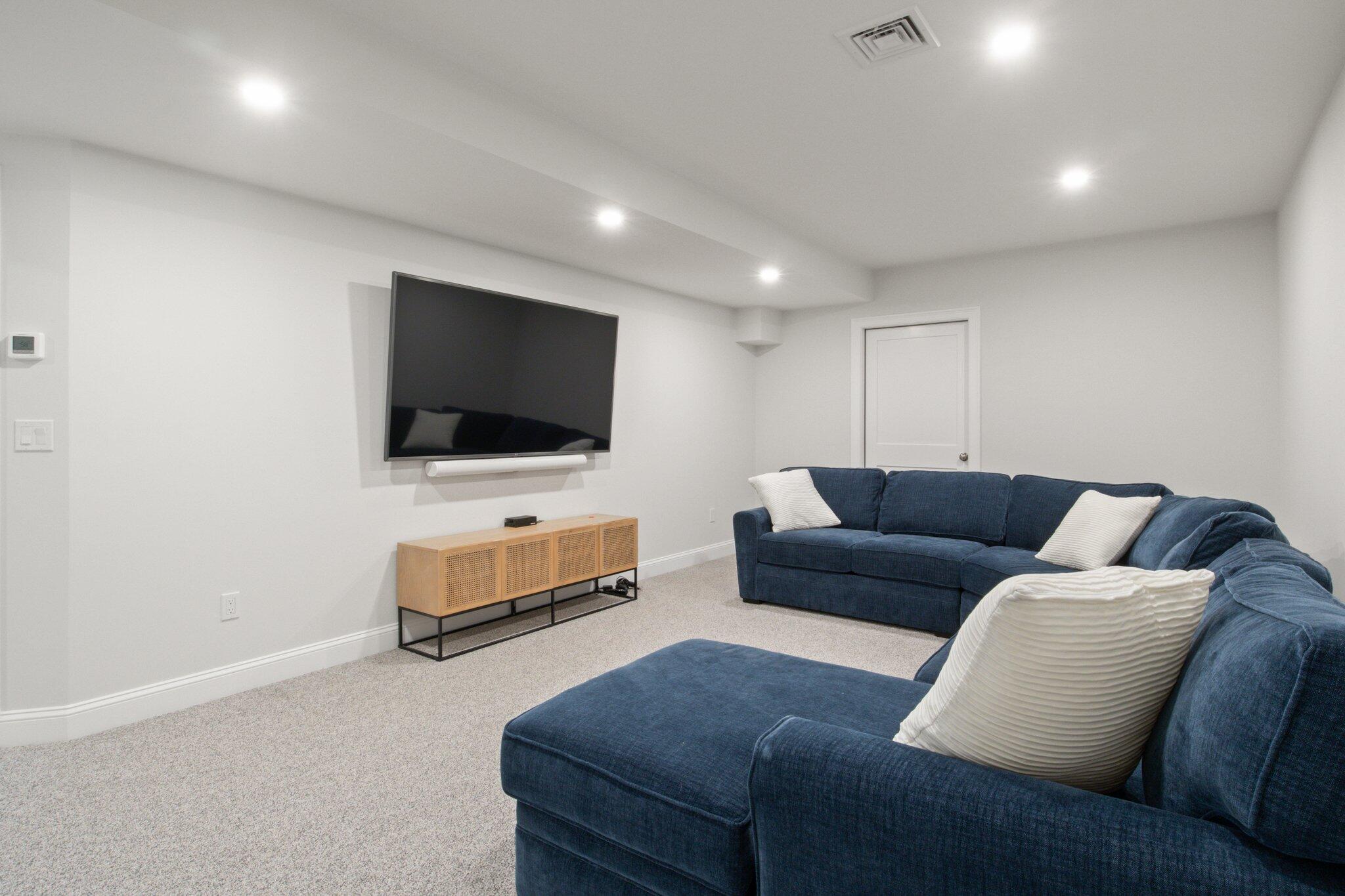 85 Cobblestone Circle Mashpee, MA 02649 - Photo 31 of 42 a living room with furniture and a flat screen tv