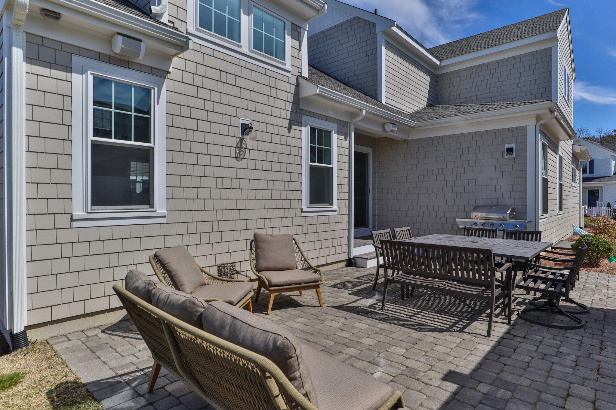 85 Cobblestone Circle Mashpee, MA 02649 - Photo 37 of 42 a backyard of a house with table and chairs