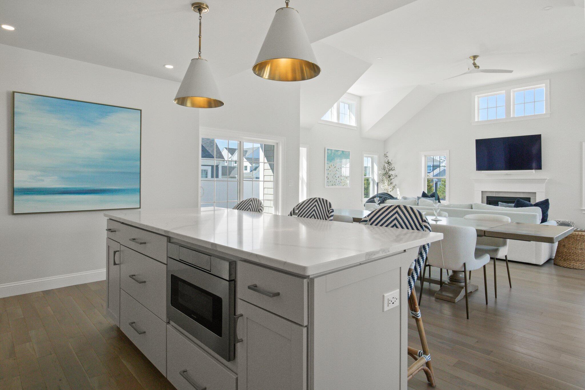85 Cobblestone Circle Mashpee, MA 02649 - Photo 7 of 42 a kitchen with a sink a stove and chairs with wooden floor