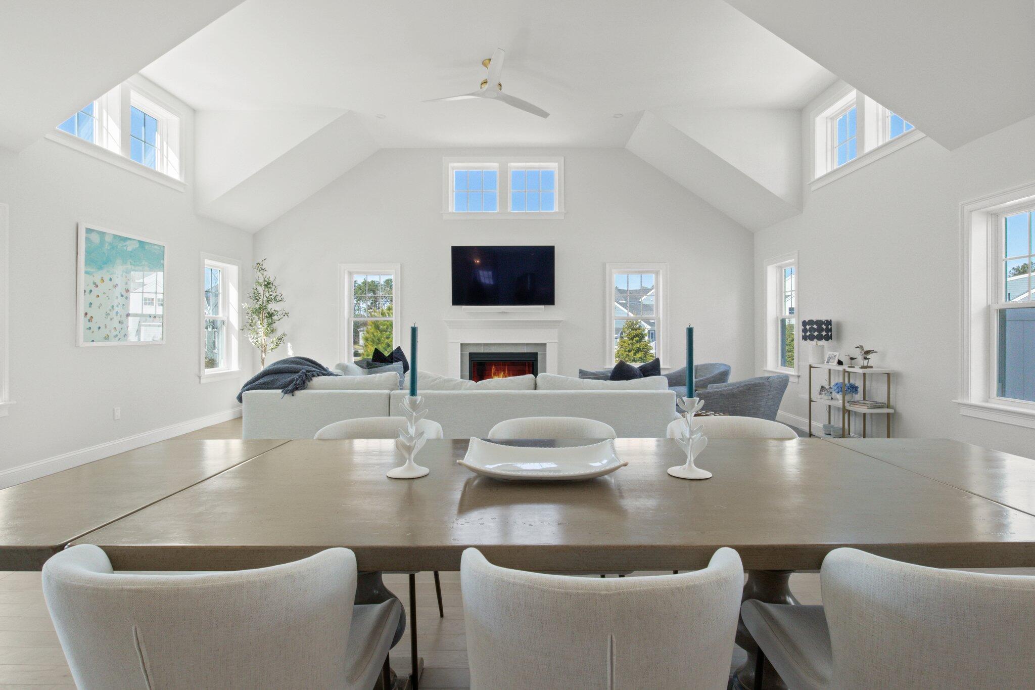 85 Cobblestone Circle Mashpee, MA 02649 - Photo 10 of 42 a dining room with furniture a fireplace and a flat screen tv