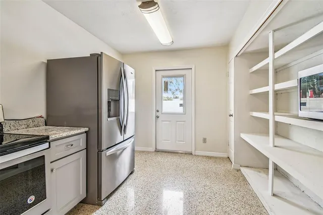 a kitchen with a refrigerator stove and cabinets