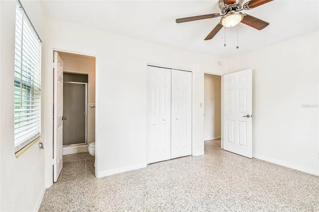 a view of a room with a ceiling fan