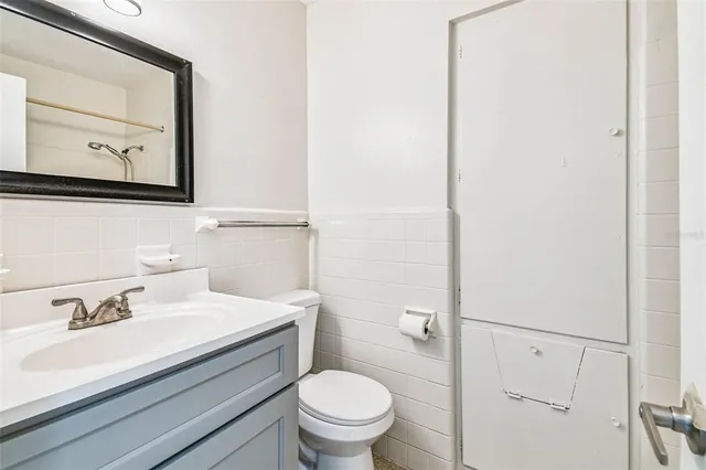 a bathroom with a sink a toilet and mirror