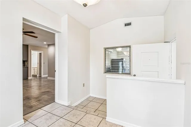 a view of kitchen with stainless steel appliances kitchen island microwave and cabinets