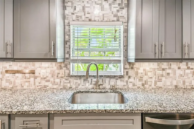 an empty room with window and ceiling fan