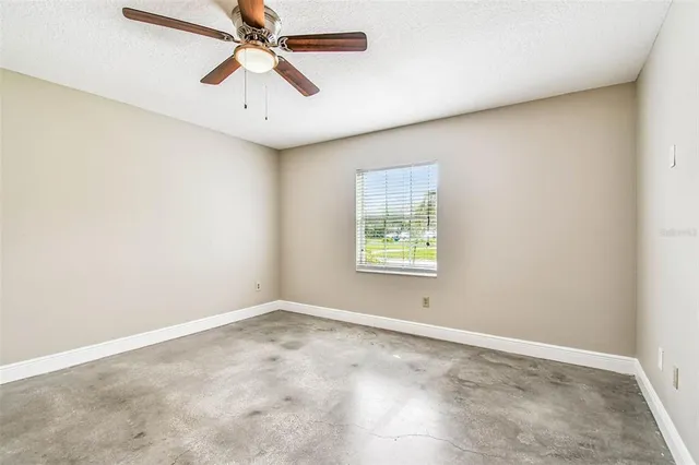 a spacious bathroom with a granite countertop tub a double vanity sink a window and a mirror