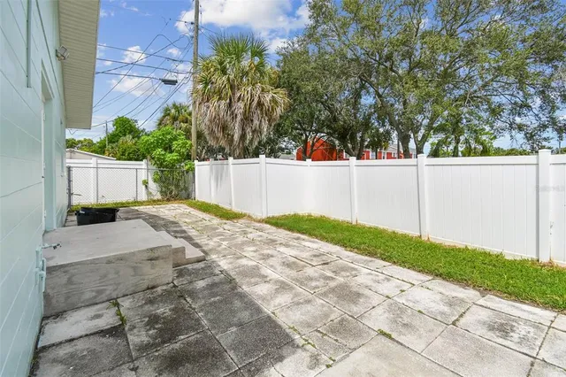 an aerial view of a house with a swimming pool yard and outdoor seating