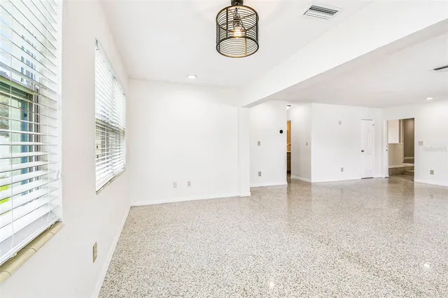 a view of room with window and wooden floor
