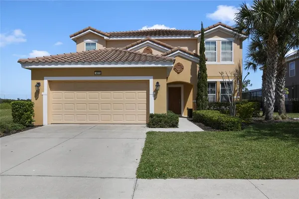 a front view of a house with a yard and garage