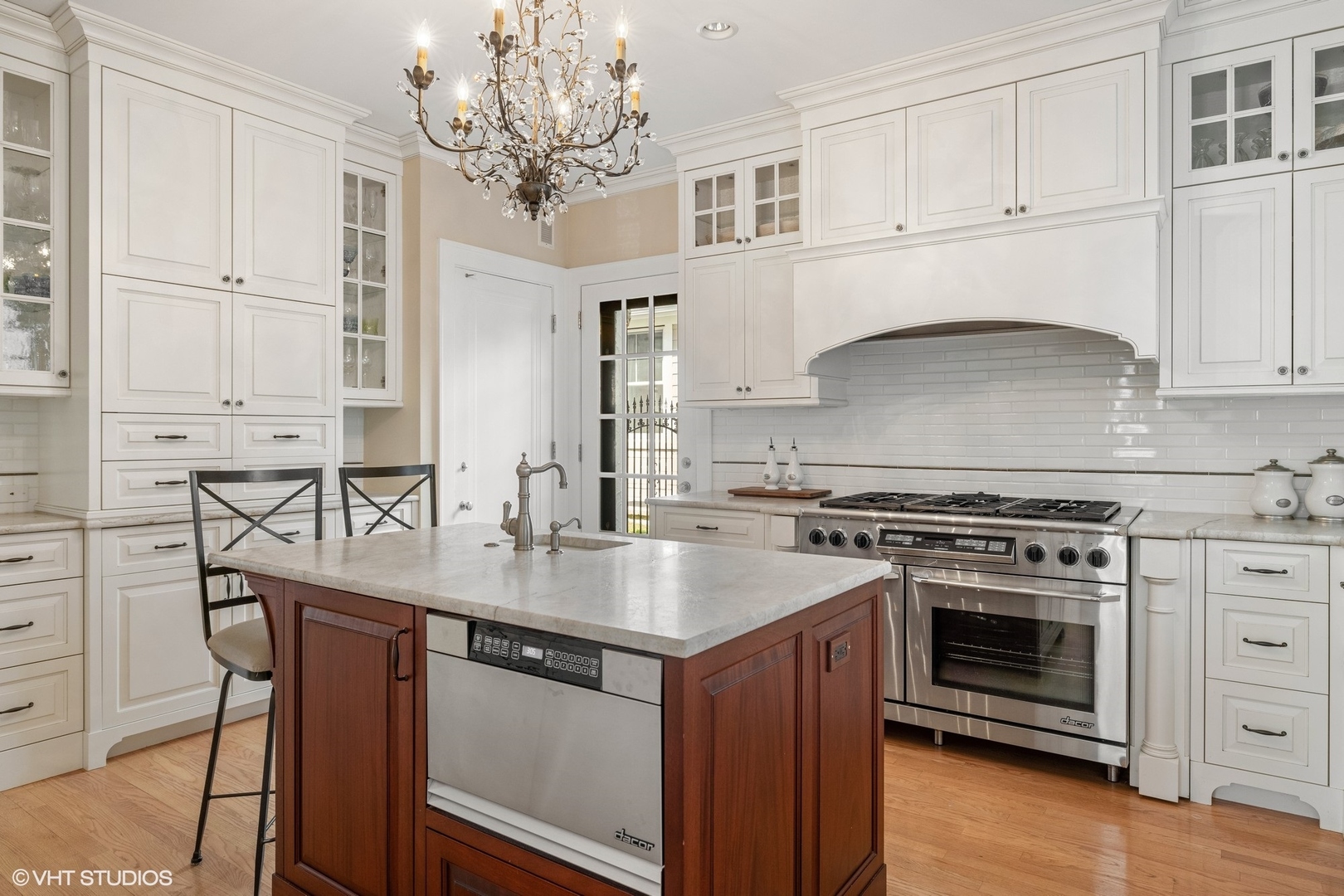 474 Ash Street Winnetka, IL 60093 - Photo 12 of 57 a kitchen with stainless steel appliances granite countertop a stove a sink and white cabinets