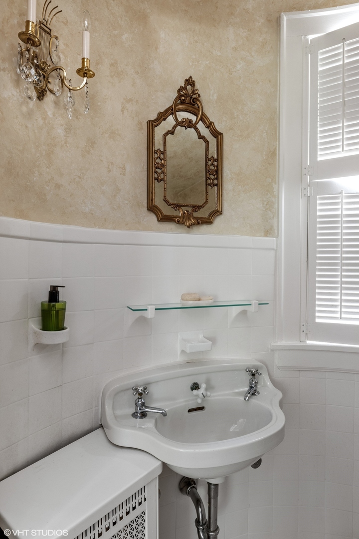 474 Ash Street Winnetka, IL 60093 - Photo 40 of 57 a bathroom with a sink and a mirror