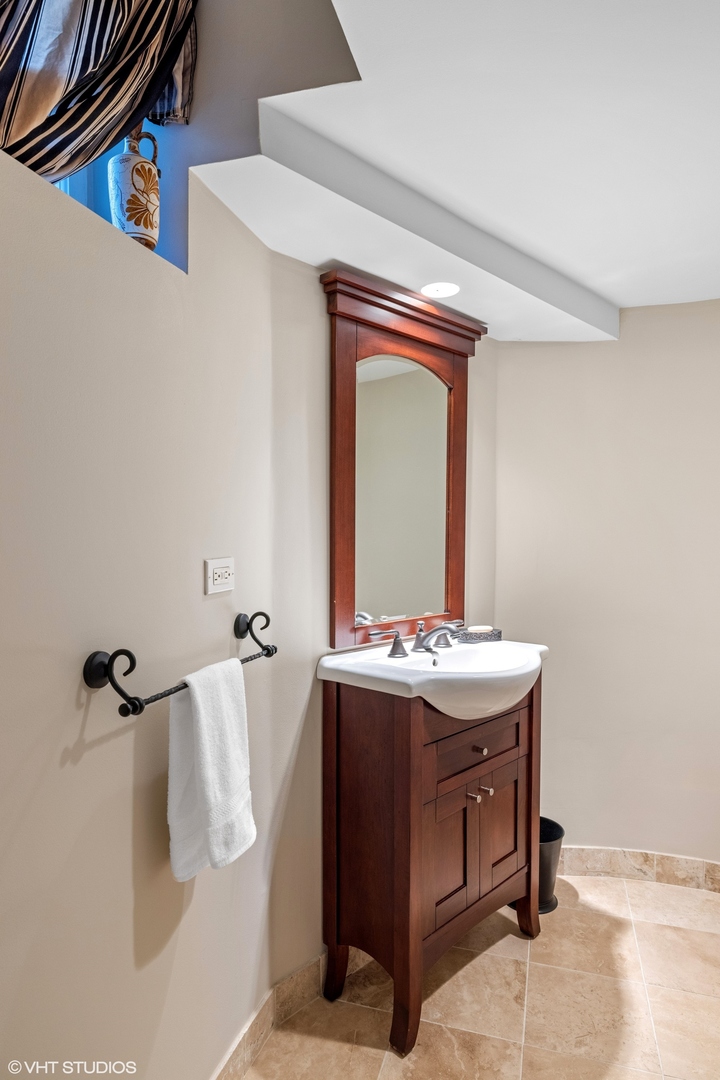 474 Ash Street Winnetka, IL 60093 - Photo 45 of 57 a bathroom with a sink and mirror