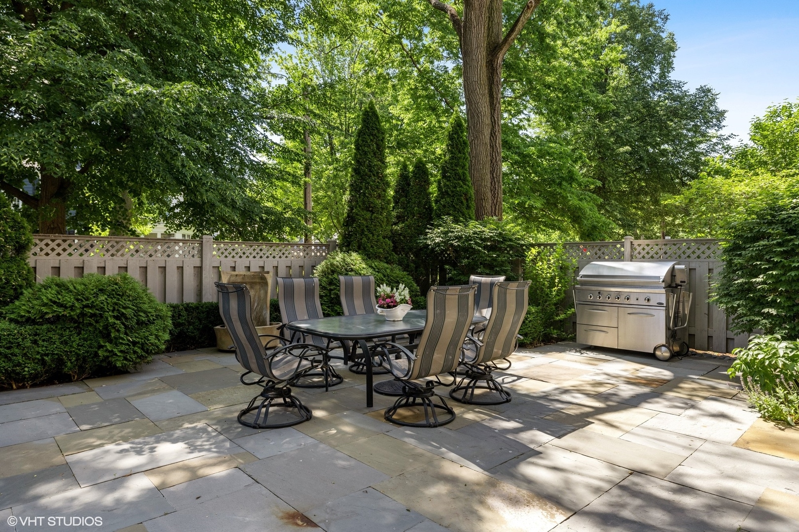 474 Ash Street Winnetka, IL 60093 - Photo 47 of 57 a view of a chairs and table in the back yard of a house